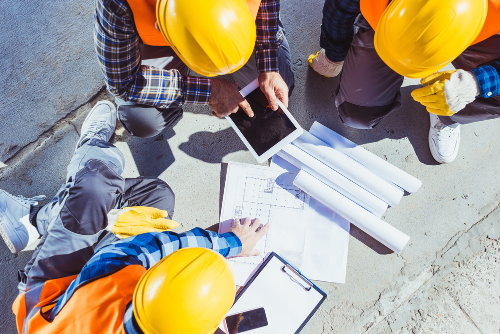 Construction-workers-gathered-to-discuss-building-plans