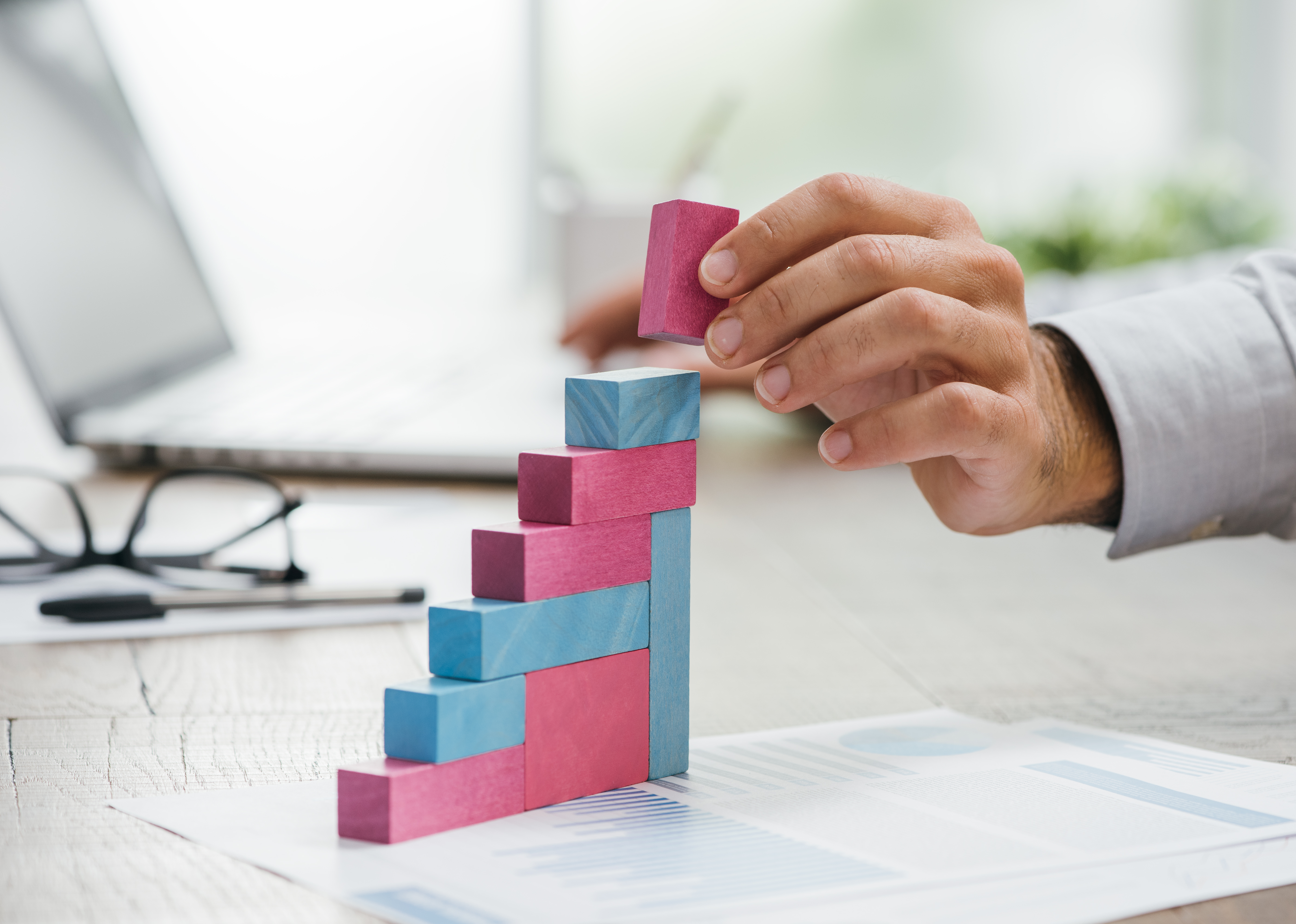 businessman-building-financial-graph-with-wooden-blocks