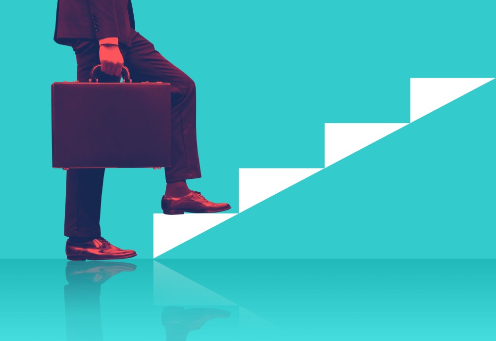 businessman-holding-briefcase-walking-up-graphic-staircase